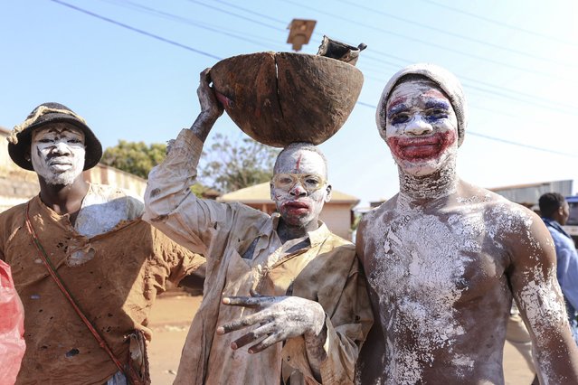 Inhabitants of Foumban pose for a portrait near the city gates during the 548th edition of the Nguon festival of the Bamoun people in Foumban on December 8, 2024. Tourists and officials flocked to a remote region to attend a governance ritual held as part of the 548th “Ngouon”, a royal festivity that dates back to 1384 when the kingdom was founded. Its rite, which puts the monarch's popularity to the test, had not been celebrated in six years but was recognised in December 2023 by UNESCO as intangible heritage of humanity. (Photo by Daniel Beloumou Olomo/AFP Photo)