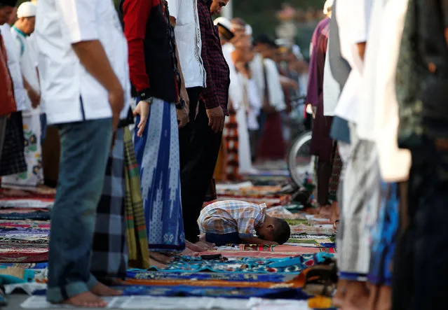 A child attends Eid al-Fitr prayers to mark the end of the holy fasting month of Ramadan at Sunda Kelapa port in Jakarta,  Indonesia July 6, 2016. (Photo by Darren Whiteside/Reuters)