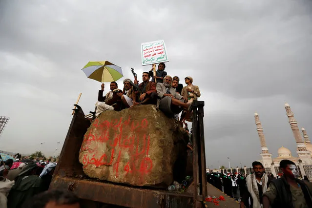 People ride on the back of a truck during a rally held by supporters of Houthi rebels and Yemen's former president Ali Abdullah Saleh to celebrate an agreement reached by Saleh and the Houthis to form a political council to unilaterally rule the country, in Sanaa, Yemen August 1, 2016. (Photo by Khaled Abdullah/Reuters)