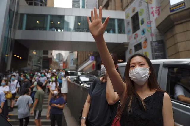 A protester gestures with five fingers, signifying the “Five demands – not one less” during a protest in Central Government Complex in Hong Kong, Wednesday, May 27, 2020. (Photo by Kin Cheung/AP Photo)