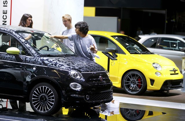 Employees clean a Fiat 500 Abarth during the media day at the Frankfurt Motor Show (IAA) in Frankfurt, Germany, September 14, 2015. (Photo by Kai Pfaffenbach/Reuters)