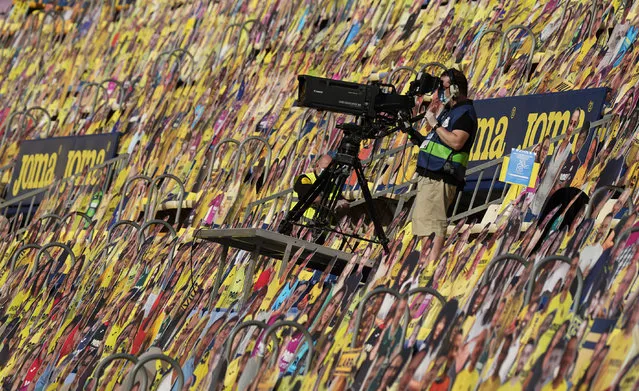 A cameraman works among cardboards of fans prior to the Spanish league football match Villarreal CF against Sevilla FC at La Ceramica stadium in Vila-real on June 22, 2020. (Photo by Jose Jordan/AFP Photo)