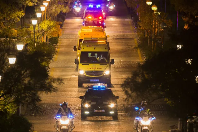 A convoy  transporting a Spanish nurse who believed to have contracted the ebola virus from a 69-year-old Spanish priest leaves Alcorcon Hospital in Madrid, Spain, Tuesday, October 7, 2014. The nurse who treated a missionary for the disease at a Madrid hospital tested positive for the virus, Spain's health minister said Monday. The female nurse was part of the medical team that treated the Spanish priest who died in a hospital last month after being flown back from Sierra Leone, where he was posted. (Photo by Andres Kudacki/AP Photo)