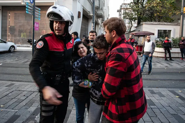 A boy separated from his parents is cared for after an explosion on Istiklal street, a busy pedestrian thoroughfare on November 13, 2022 in Istanbul, Turkey. (Photo by Burak Kara/Getty Images)