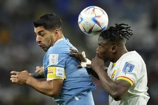 Ghana's Mohammed Salisu, right, challenges Uruguay's Luis Suarez during the World Cup group H soccer match between Ghana and Uruguay, at the Al Janoub Stadium in Al Wakrah, Qatar, Friday, December 2, 2022. (Photo by Ashley Landis/AP Photo)