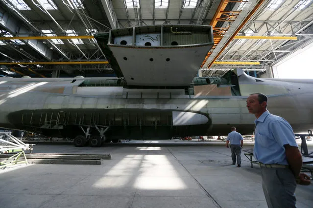Employees stand near an airframe for the second Antonov-225 Mriya plane at Antonov aircraft plant in Kiev, Ukraine, September 7, 2016. Ukraine hopes to attract $500 million of investment from China to complete an updated version of the world's biggest aircraft, the Antonov-225 Mriya, the president of manufacturer Antonov said on Wednesday. The Antonov-225 is a cargo plane designed as part of the former Soviet Union's space programme. The only one completed is still in use and can carry up to 250 tonnes up to 4,000 km (2,485 miles). Work to manufacture a second plane was started in 1988 and never completed, but Antonov has now found a potential investor in the Aerospace Industry Corporation of China (AICC). (Photo by Valentyn Ogirenko/Reuters)