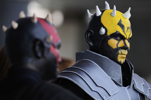Star Wars fans wearing costumes of Darth Maul, left, and his brother Savage Opress pose for a photo outside the venue during a fan convention called the Star Wars Celebration in Chiba, near Tokyo, Friday, April 18, 2025. (Photo by Hiro Komae/AP Photo)