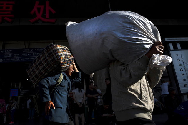 Migrant workers arrive at the Beijing West Railway Station in Beijing on May 26, 2016. Rural workers have been streaming into China's urban centers for years as the economy of the country has shifted from rural to urban. Beijing has been particularly attractive as the city plans to join neighboring Tanjin to form a supercity of over 100 million inhabitants. (Photo by Michael Robinson Chavez/The Washington Post)