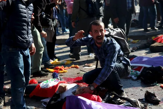 A man asks for help for an injured woman after an explosion during a peace march in Ankara, Turkey, October 10, 2015. (Photo by Tumay Berkin/Reuters)