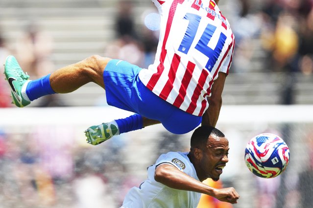 Botafogo's Marlon Freitas, bottom, heads a ball next to Atletico Madrid's Marcos Llorente during the Club World Cup Group B soccer match between Atletico Madrid and Botafogo in Pasadena, Calif., Monday, June 23, 2025. (Photo by Jae Hong/AP Photo)