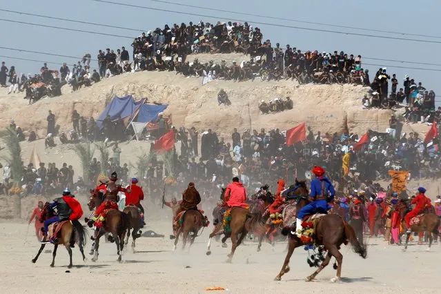 Iraqi Shi'ite Muslims ride horses as they re-enact a scene from the 7th century battle of Karbala to commemorate Ashura, the holiest day on the Shi'ite Muslim calendar, amid the spread of the coronavirus disease (COVID-19), in the holy city of Najaf, August 30, 2020. (Photo by Alaa Al-Marjani/Reuters)