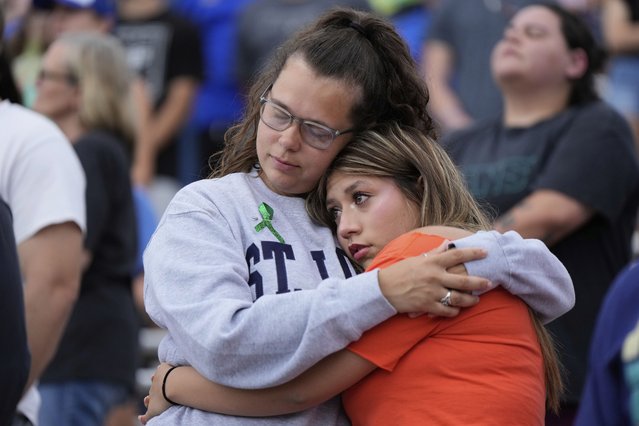 Mourners embrace during a vigil for Guadalupe River flooding victims at Tivy Antler Stadium on Wednesday, July 9, 2025, in Kerrville, Texas. (Photo by Ashley Landis/AP Photo)