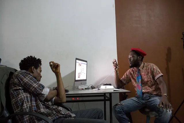 Nigerian musician, Villy (L) and fashion stylist Daniel Quist relax at a photo studio in the Osu district of Accra, Ghana, July 2, 2015. (Photo by Francis Kokoroko/Reuters)