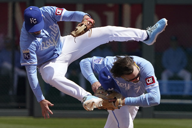 Nick Loftin #12 of the Kansas City Royals leaps over Bobby Witt Jr. #7 as Witt Jr. fields a ball hit by Victor Caratini #17 of the Houston Astros in the fourth inning at Kauffman Stadium on April 11, 2024 in Kansas City, Missouri. (Photo by Ed Zurga/Getty Images/AFP Photo)