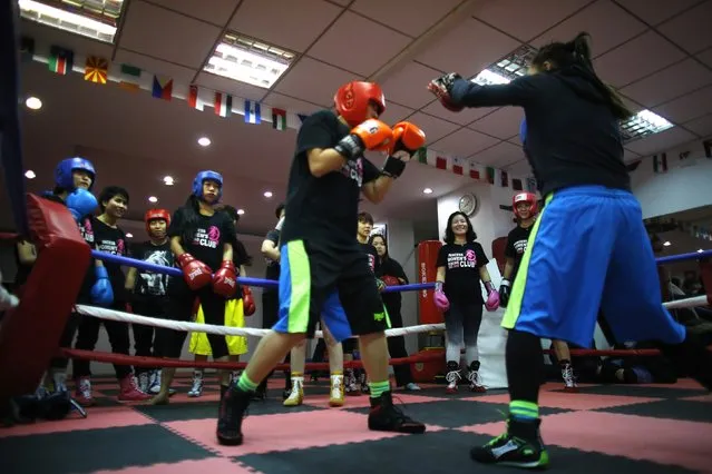 Women attend a boxing class at Princess Women's Boxing Club in Shanghai December 3, 2014. (Photo by Carlos Barria/Reuters)