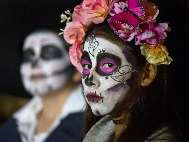 Participants gather before the start of a candlelight procession at the end of a three-day "Day of The Dead" (Dia de los Muertos) celebration in Old Town San Diego, California, November 2, 2015. (Photo by Mike Blake/Reuters)