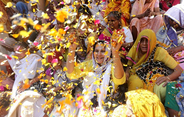 Indian widows throw petals as they participate in Holi festivities in Vrindavan, Uttar Pradesh, India, 06 March 2023. Hundreds of widows from Vrindavan gathered for the tradition of the Hindu spring festival Holi, also known as Festival of Colors, that marks the beginning of the spring season and will be celebrated across the country on 08 March. (Photo by Harish Tyagi/EPA)