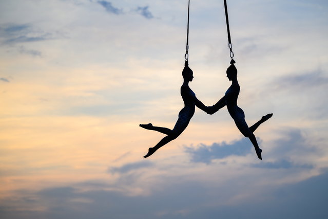 Aerialists of the Hungarian troupe Vincze Tunde Production perform on the opening night of Strand Festival in Zamardi, Hungary, 20 August 2025. (Photo by Tamas Vasvari/EPA)