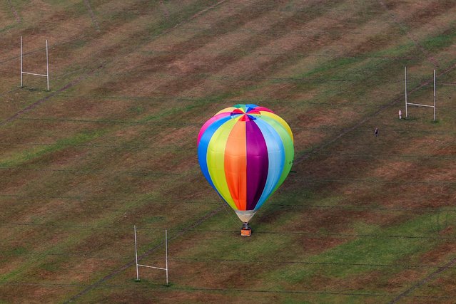 A hot air balloon lands on a sports field at the annual Bristol International Balloon Fiesta in Bristol, Britain, on August 8, 2025. (Photo by Toby Melville/Reuters)