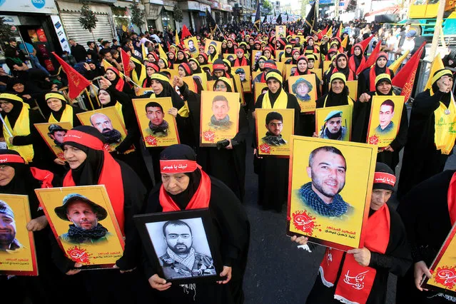 Hezbollah women supporters carry pictures of dead Hezbollah members as they march during a religious procession, to mark the burning of the tents that is part of the Ashura religious ceremony in Nabatiyeh, South Lebanon October 15, 2016. (Photo by Ali Hashisho/Reuters)