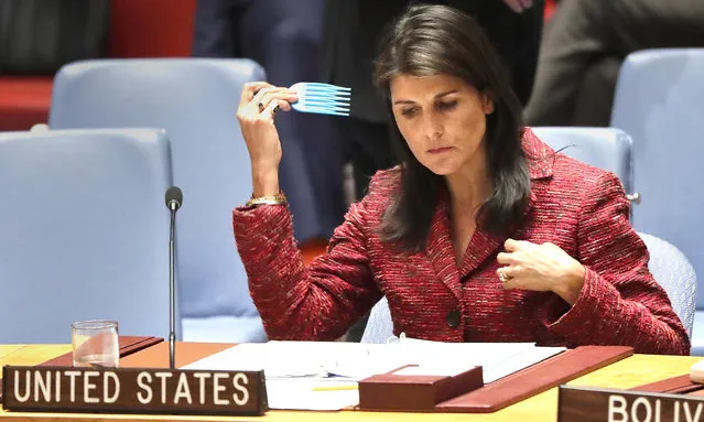 Nikki Haley, United States Ambassador to the United Nations, combs her hair before the start of a Security Council meeting, Tuesday, April 10, 2018, at U.N. headquarters. The U.N. Security Council has rejected a Russian resolution that would have created a new expert body to determine responsibility for chemical weapons attacks in Syria. Haley said the draft resolution was not impartial or independent since it would allow Russia to veto investigators and staff for the new body – and to block its findings. (Photo by Julie Jacobson/AP Photo)