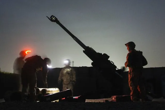 U.S. soldiers from the 3rd Cavalry Regiment take part in an artillery exercise on forward operating base Gamberi in the Laghman province of Afghanistan December 24, 2014. (Photo by Lucas Jackson/Reuters)