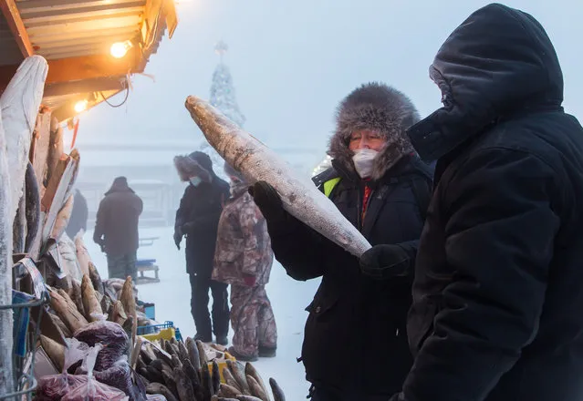 Local people shop for fish at Central Market in freezing conditions of minus 43 degrees Celsius in the city of Yakutsk, Sakha (Yakutia), Russia on December 13, 2020. Yakutsk is located about 280 miles (450km) south of the Arctic Circle and is the capital city of Russia’s Sakha Republic. (Photo by Yevgeny Sofroneyev/TASS)