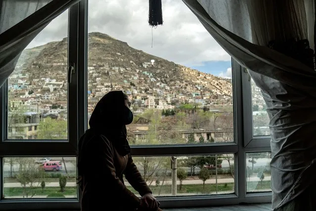 Tarawat, a 17-year-old girl who has stopped studying, looks out from a window in her room, in Kabul, Afghanistan, on Saturday, March 25, 2023. The new Afghan educational year started, but high school remained closed for girls for the second year after Taliban returned to power in 2021. (Photo by Ebrahim Noroozi/AP Photo)