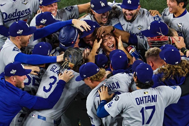 Los Angeles Dodgers pitcher Yoshinobu Yamamoto is swarmed by teammates after the Dodgers won the World Series on Saturday, November 2, 2025. Yamamoto finished Game 7 and shut down the Toronto Blue Jays as the Dodgers won 5-4 in 11 innings. Yamamoto was named World Series MVP, winning three games. The Dodgers are the first team to win back-to-back titles since the New York Yankees won three in a row from 1998-2000. (Photo by Patrick Smith/Getty Images)