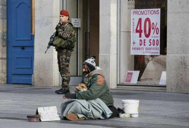 A French paratrooper is seen in front of a shop in the center of Lyon, France, November 27, 2015 as the security measures in public places is reinforced after recent deadly attacks in Paris. (Photo by Robert Pratta/Reuters)
