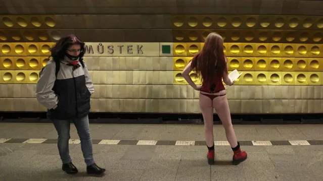 A passenger (R) not wearing pants waits for a subway train during the “No Pants Subway Ride” in Prague January 11, 2015. (Photo by David W. Cerny/Reuters)