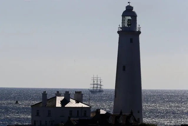 A tall ship sails past St Mary’s Lighthouse as part of the tall ships regatta at Whitley Bay, England on August 26, 2016. (Photo by Owen Humphreys/PA Wire)