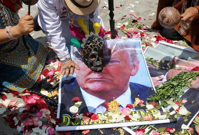 Peruvian shamans with poster of U.S. Republican presidential candidate Donald Trump perform a ritual of predictions ahead of the U.S. presidential elections, at Lima, Peru November 7, 2016. (Photo by Mariana Bazo/Reuters)