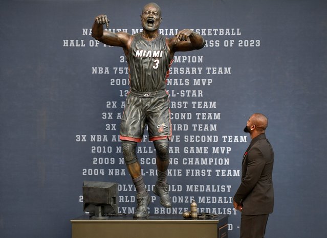 Former Miami Heat NBA basketball player Dwyane Wade looks at a bronze statue in his image during its unveiling ceremony outside Kaseya Center, Sunday, October 27, 2024, in Miami, Fla. (Photo by Michael Laughlin/AP Photo)