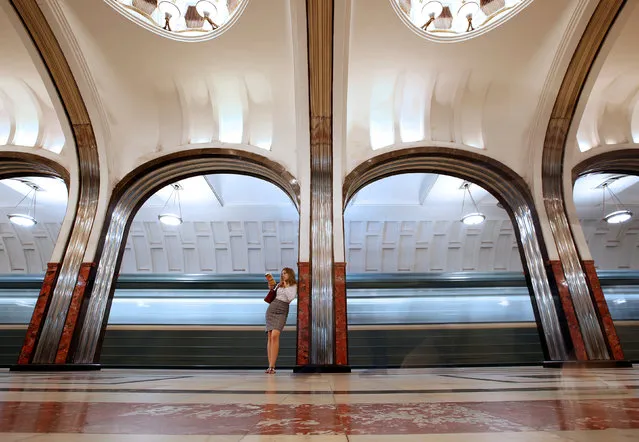 A woman reads a book at Mayakovskaya metro station in Moscow, Russia, June 22, 2018. As well as shooting all the matches, Reuters photographers are producing pictures showing their own quirky view from the sidelines of the World Cup. (Photo by Christian Hartmann/Reuters)