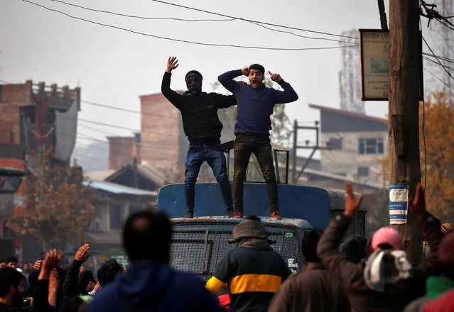 Demonstrators shout slogans on top of a police vehicle during the funeral of Rizwan Ahmad, 21, who according to local media was hit by a police vehicle a week ago on the outskirts of Srinagar, and succumbed to his injuries on Monday in Srinagar, November 14, 2016. (Photo by Danish Ismail/Reuters)