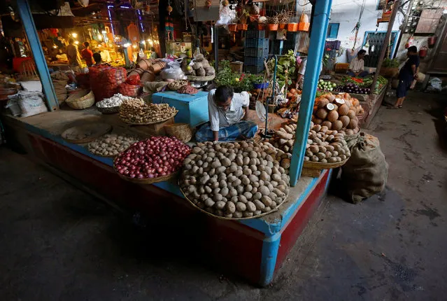 Vegetable vendors wait for customers at their stalls at a market in Kolkata, India, November 14, 2016. (Photo by Rupak De Chowdhuri/Reuters)
