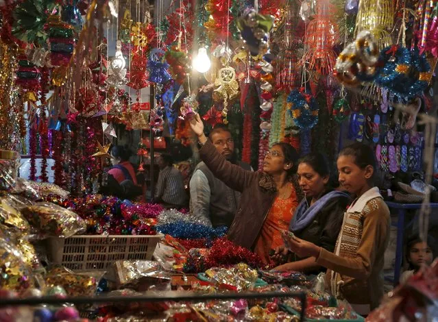 Women shop for Christmas decorations at a roadside market in Ahmedabad, India, December 23, 2015. (Photo by Amit Dave/Reuters)