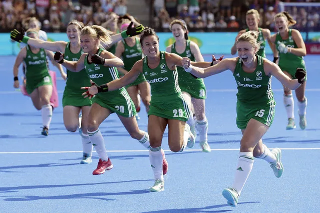 Ireland's Chloe Watkins, left, Anna O'Flanagan, centre, and Gillian Pinder celebrate winning a shootout with their teammates to win the semifinal match between Ireland and Spain during the Women's Hockey World Cup at the Lee Valley Hockey and Tennis Centre in London, Saturday August 4, 2018. (Photo by Tim Ireland/AP Photo)