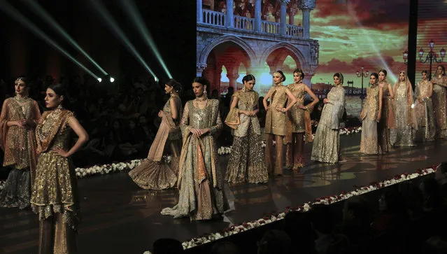 Models present creations of designer Umsha by Uzama Babar during Bridal Couture Week 2016 in Lahore, Pakistan, Sunday, November 27, 2016. (Photo by K.M. Chaudary/AP Photo)