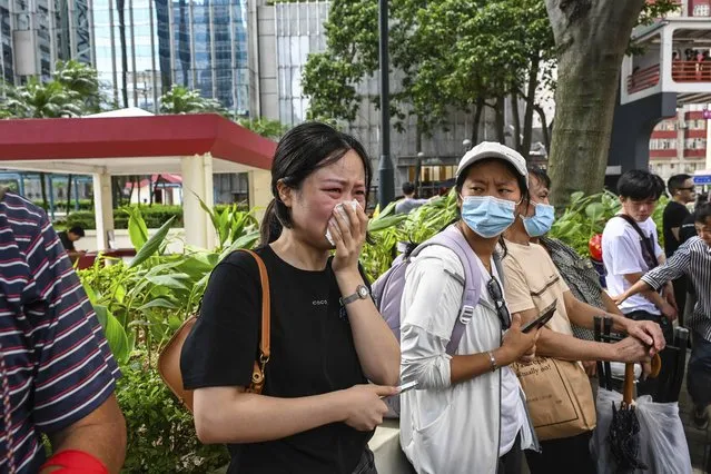 People react during a funeral for Coco Lee outside a funeral home in Hong Kong, Tuesday, August 1, 2023. (Photo by Billy H.C. Kwok/AP Photo)