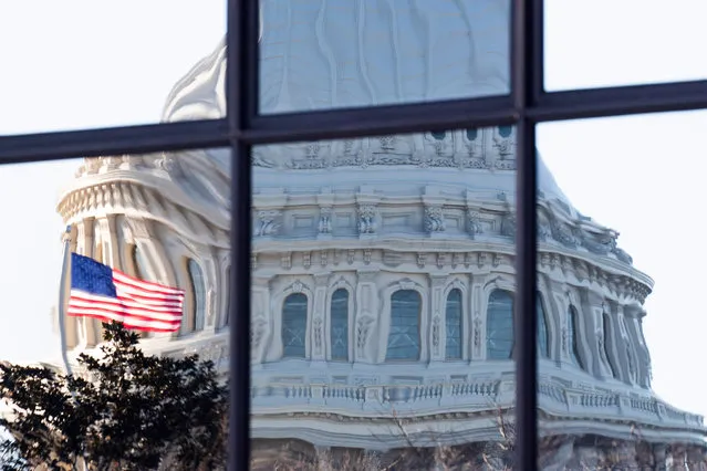 The image of the US Capitol Building is seen reflected in glass windows in Washington, DC, USA, 08 December 2020. Lawmakers are set to extend a deadline by one week to prevent a partial government shutdown as a temporary spending bill is set to expire on 11 December. (Photo by Michael Reynolds/EPA/EFE)