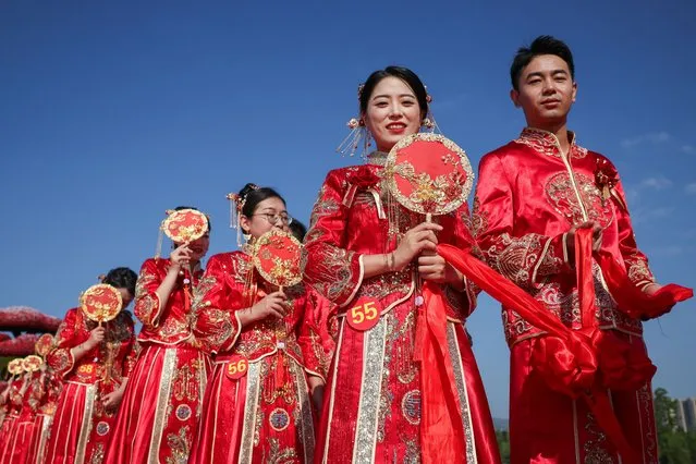 Newly-wed couples attend traditional Chinese style group wedding ceremony at Jinyang Lake Park on September 12, 2023 in Taiyuan, Shanxi Province of China. (Photo by Hu Yuanjia/VCG via Getty Images)