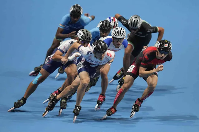 Zhenhai Zhang, right, of China, and Yan-Cheng Chen, left, of Taiwan, compete during the men's Speed Skating 10000m Point-Elimination Race event of the 19th Asian Games in Hangzhou, China, Saturday, September 30, 2023. (Photo by Aaron Favila/AP Photo)