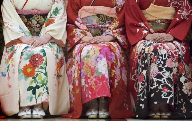 View of young women in kimonos at the Seijin no Hi (Coming-of-Age) ceremony in Kanazawa, Japan on January 10, 2016.  Japanese men and women who have reached the legal age of 20 over the past year were honored as shin-seijin or “new adult” during the national holiday. For most young people, the ceremony is an opportunity to dress in their most formal clothes that emphasize the old Japanese traditions.  Women dressed in fine silk kimonos complete with fancy hair styles, nails, fur collars, makeup and accessories. (Photo by Linda Davidson/The Washington Post)