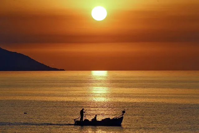 Fishers go on sea during sunset in Trabzon province in the Black Sea region of Turkey on June 20, 2021. (Photo by Hakan Burak Altunoz/Anadolu Agency via Getty Images)