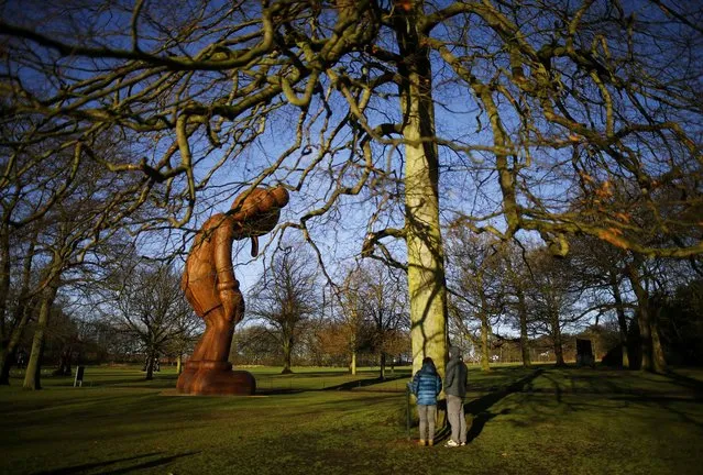 Visitors look at a sculpture entitled “Small Lie” by American artist Kaws at the Yorkshire Sculpture Park in Wakefield, Britain February 3, 2016. (Photo by Darren Staples/Reuters)