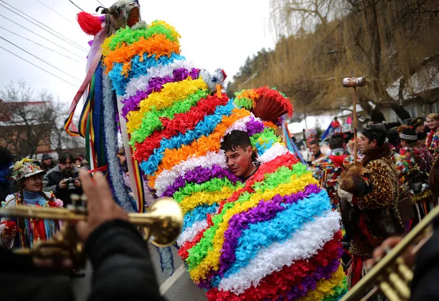 A man performs the goat's dance as musicians play next to him in the town of Comanesti, Romania December 30, 2016. (Photo by Stoyan Nenov/Reuters)