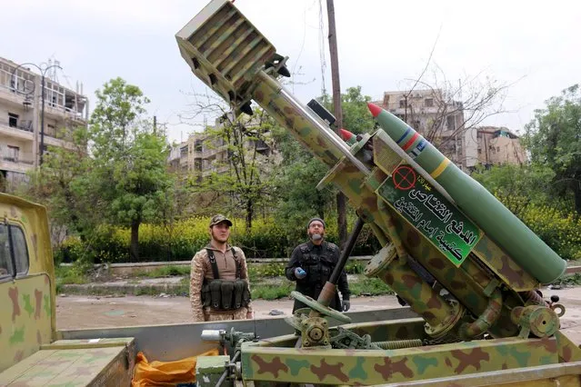 A rebel fighter of al-Jabha al-Shamiya (the Shamiya Front) uses a remote control to adjust the direction of a new locally-made cannon named “al-Qannas” (Sniper), before launching it towards forces loyal to Syria's President Bashar al-Assad stationed in Hanano barracks in Aleppo April 8, 2015. (Photo by Abdalrhman Ismail/Reuters)