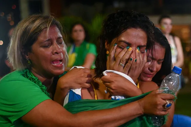 Supporters of Brazilian President and re-election candidate Jair Bolsonaro react after their candidate lost the presidential runoff election in Rio de Janeiro, Brazil, on October 30, 2022. Brazil's veteran leftist Luiz Inacio Lula da Silva was elected president Sunday by a hair's breadth, beating his far-right rival in a down-to-the-wire poll that split the country in two, election officials said. (Photo by Andre Borges/AFP Photo)